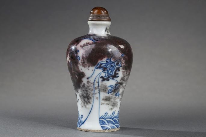 Snuff bottle porcelain enamelled in underglaze blue and copper red decorated with a Dragon in a clouds | MasterArt